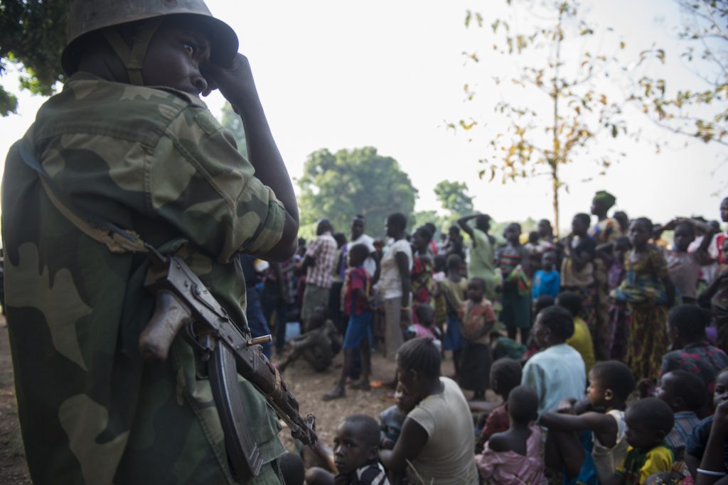 Congolese military keep an eye on South Sudanese refugees during the registration by UNHCR in Bitima village. Since November, thousands of refugees have fled from Western Equatoria to northern DRC.