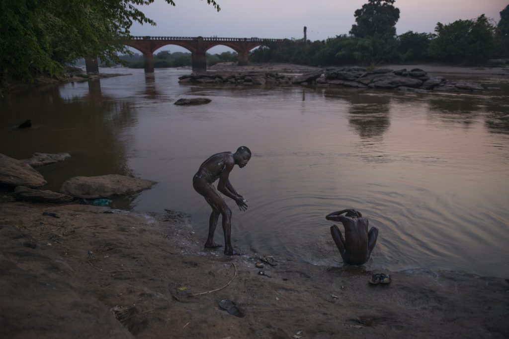 Mohamed,22, et Moussa,19, washing in Dungu river in northern DR Congo. Moussas father fled from south Soudan in 1998. When his father went back, he stayed in Congo with his congolese mother.
