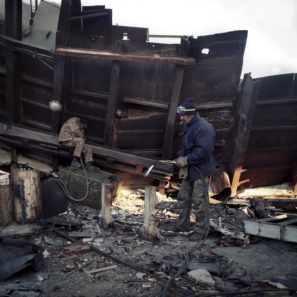 Kazakhs dismanteling the military antena of object n°38 for scrap metal.