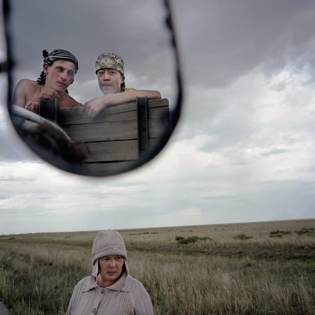 Alya, a kazakh woman, watches her son and his russian friend.