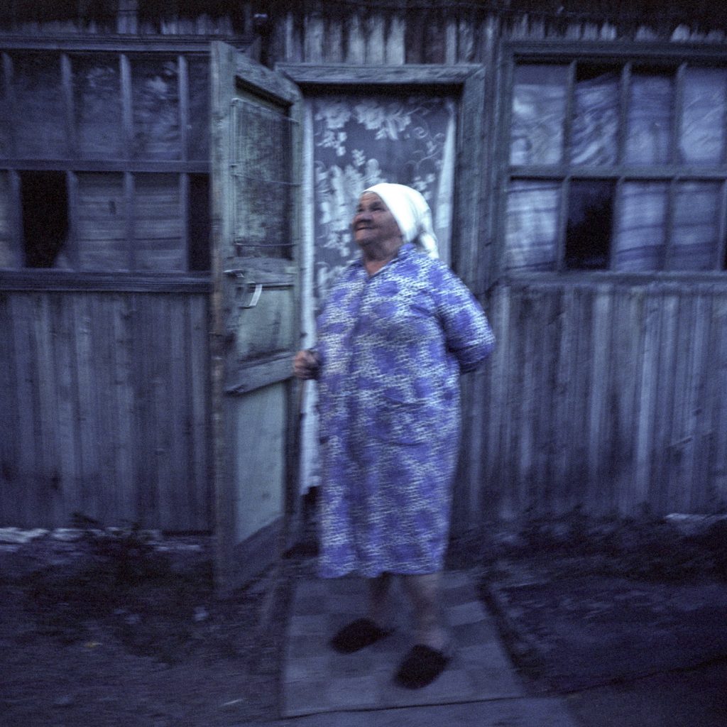 Valer's mother, Baboushka Tonia, 81 years old, in front of her son's home. She arrived in Shagan in 1956.